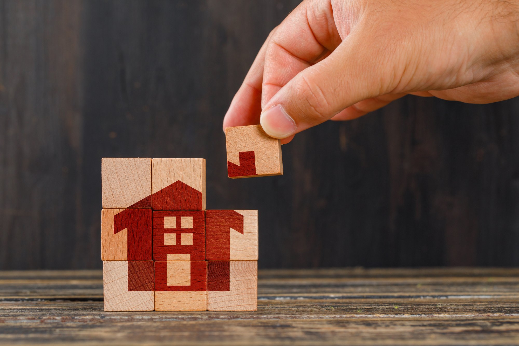 stay-home-concept-wooden-table-side-view-hand-holding-wooden-cube-2 stay-home-concept-wooden-table-side-view-hand-holding-wooden-cube-2